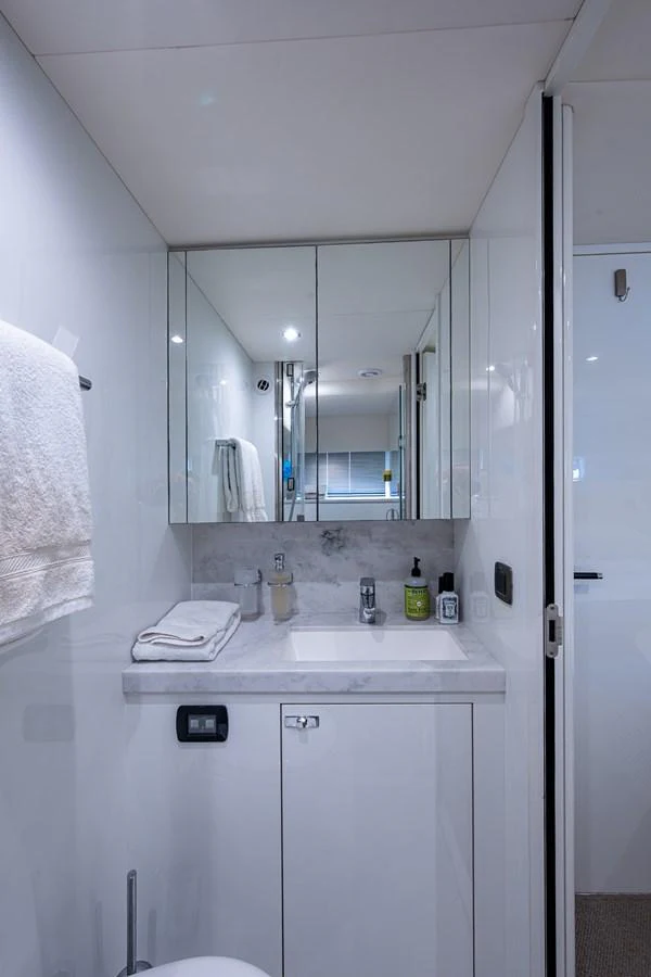 a bathroom with a sink and mirror aboard SPLASH Yacht for Sale