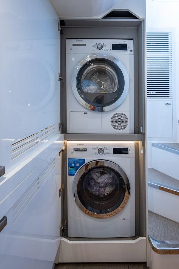 a washing machine in a room aboard SPLASH Yacht for Sale