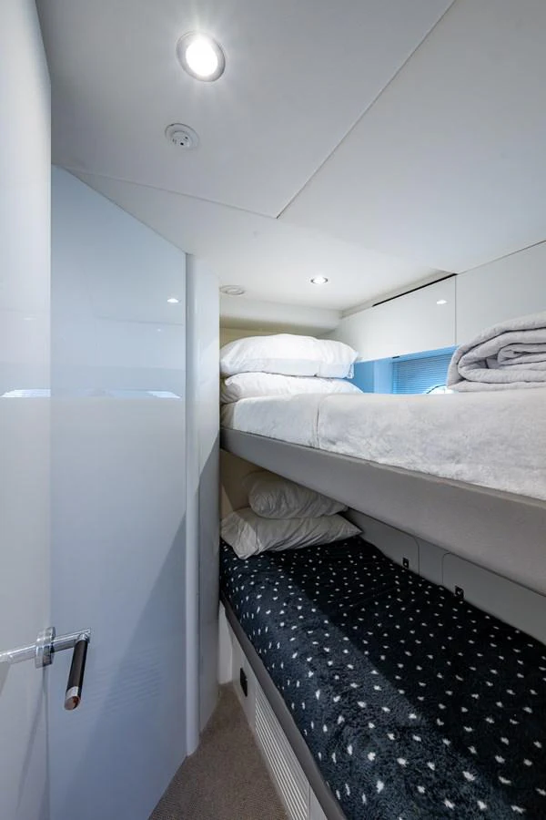 a room with a bed and a mirror aboard SPLASH Yacht for Sale