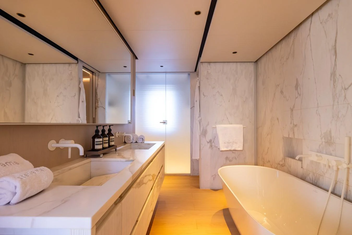 a bathroom with a bathtub and sink aboard STELLAMAR Yacht for Sale