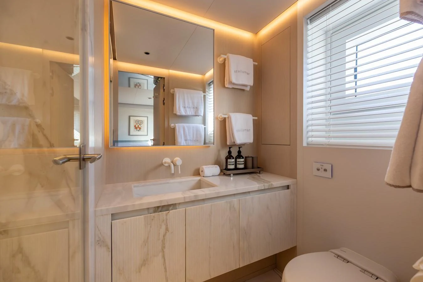 a bathroom with a sink and a mirror aboard STELLAMAR Yacht for Sale