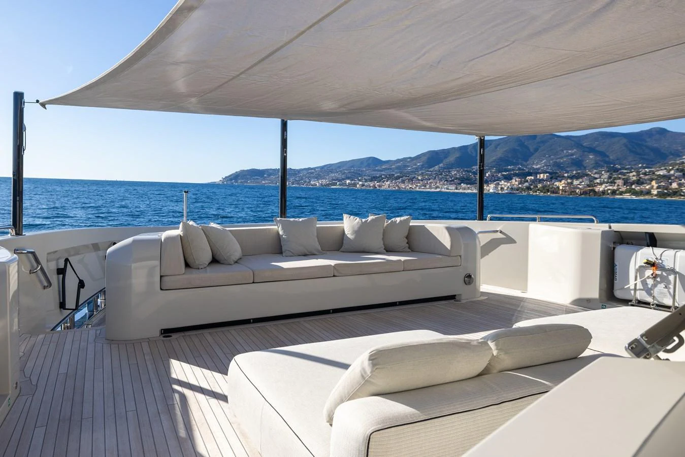 a couch on a deck overlooking a body of water aboard STELLAMAR Yacht for Sale