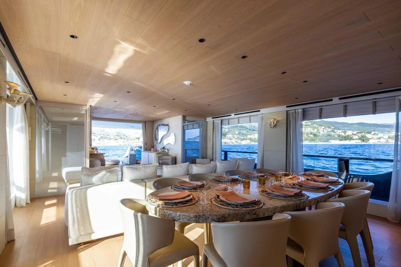 a dining room with a large window aboard STELLAMAR Yacht for Sale
