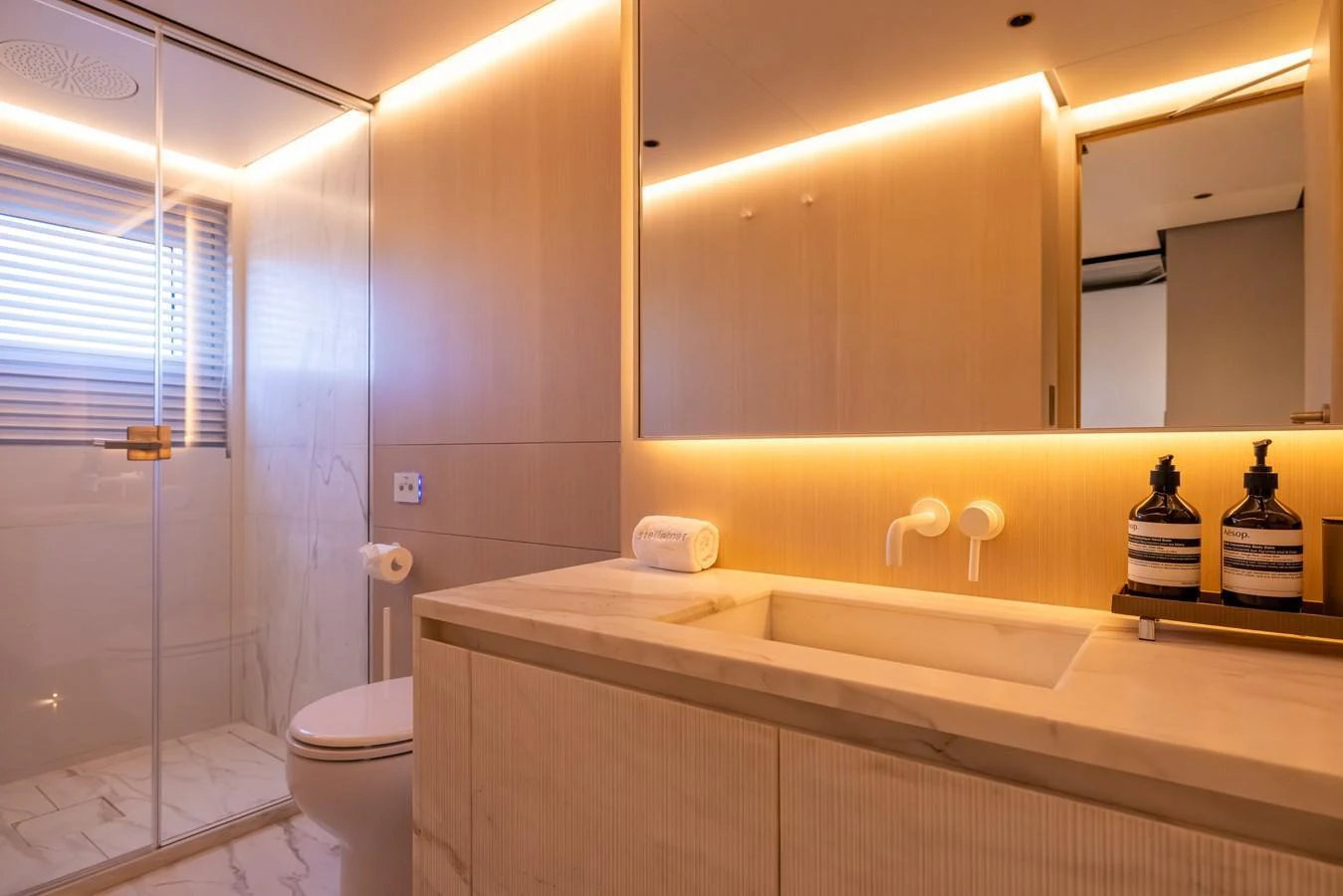 a bathroom with a tub sink and toilet aboard STELLAMAR Yacht for Sale
