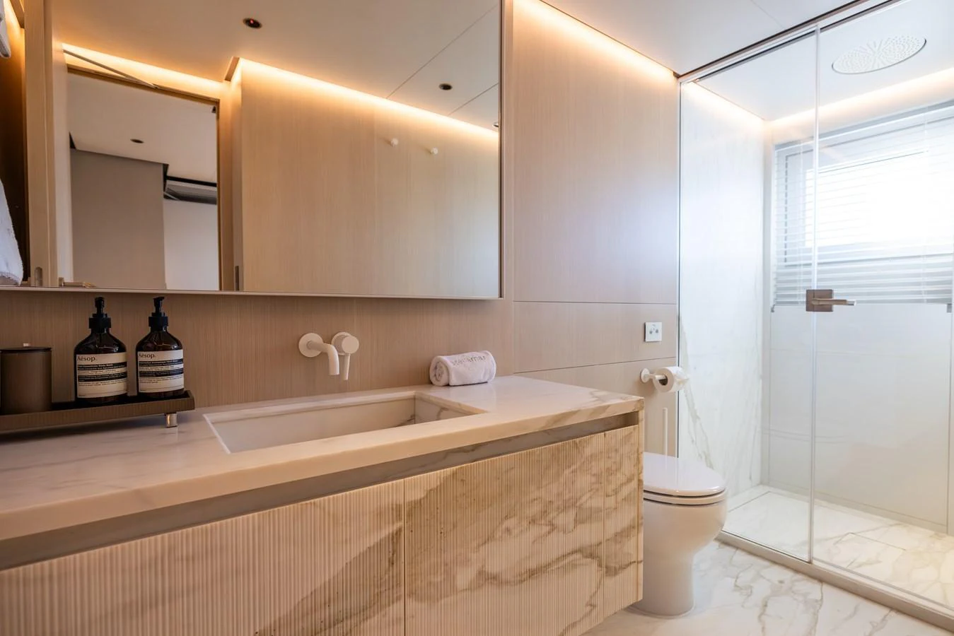 a bathroom with a tub sink and toilet aboard STELLAMAR Yacht for Sale