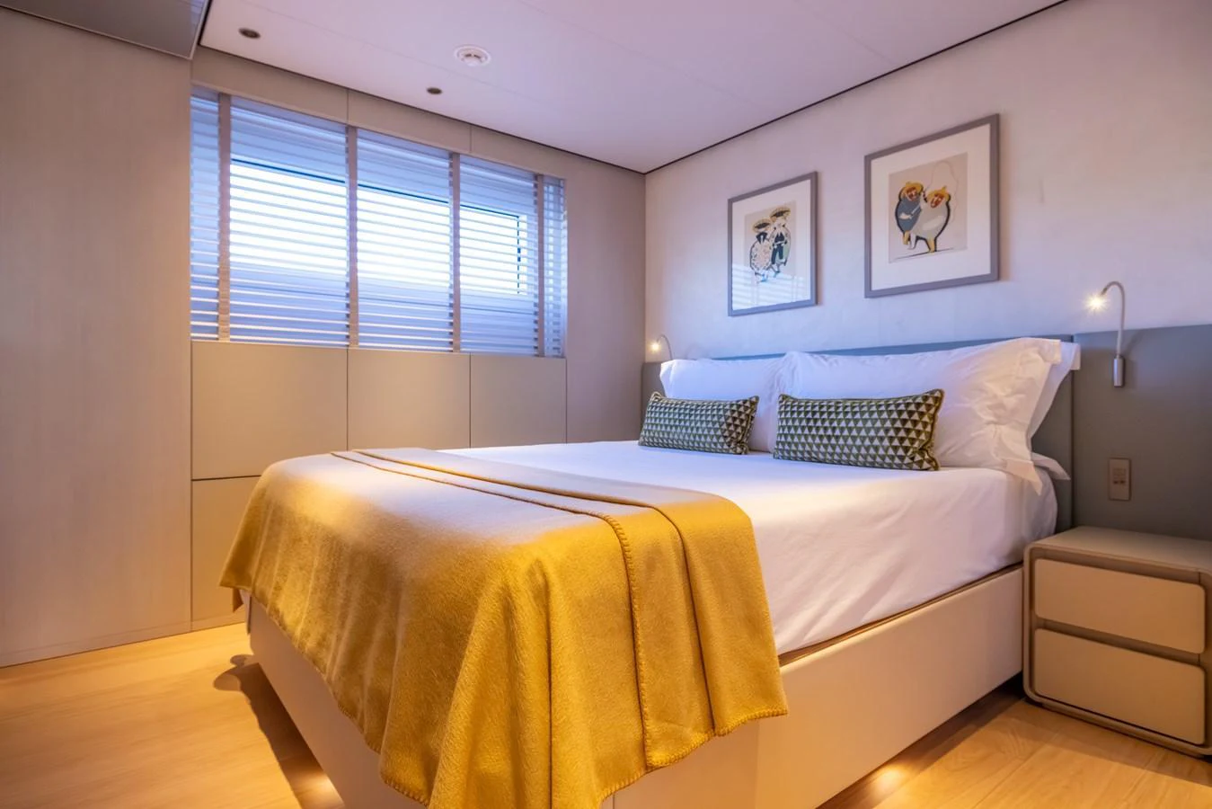 a bedroom with a bed and a window aboard STELLAMAR Yacht for Sale
