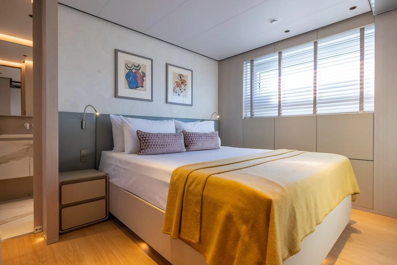 a bedroom with a bed and a window aboard STELLAMAR Yacht for Sale