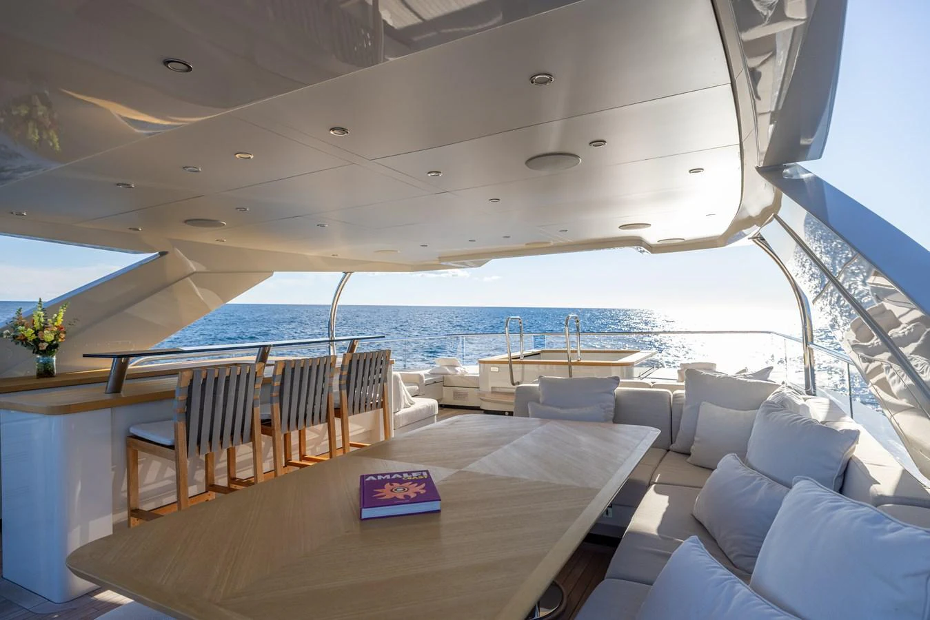 a large living room with a large balcony overlooking the ocean aboard STELLAMAR Yacht for Sale
