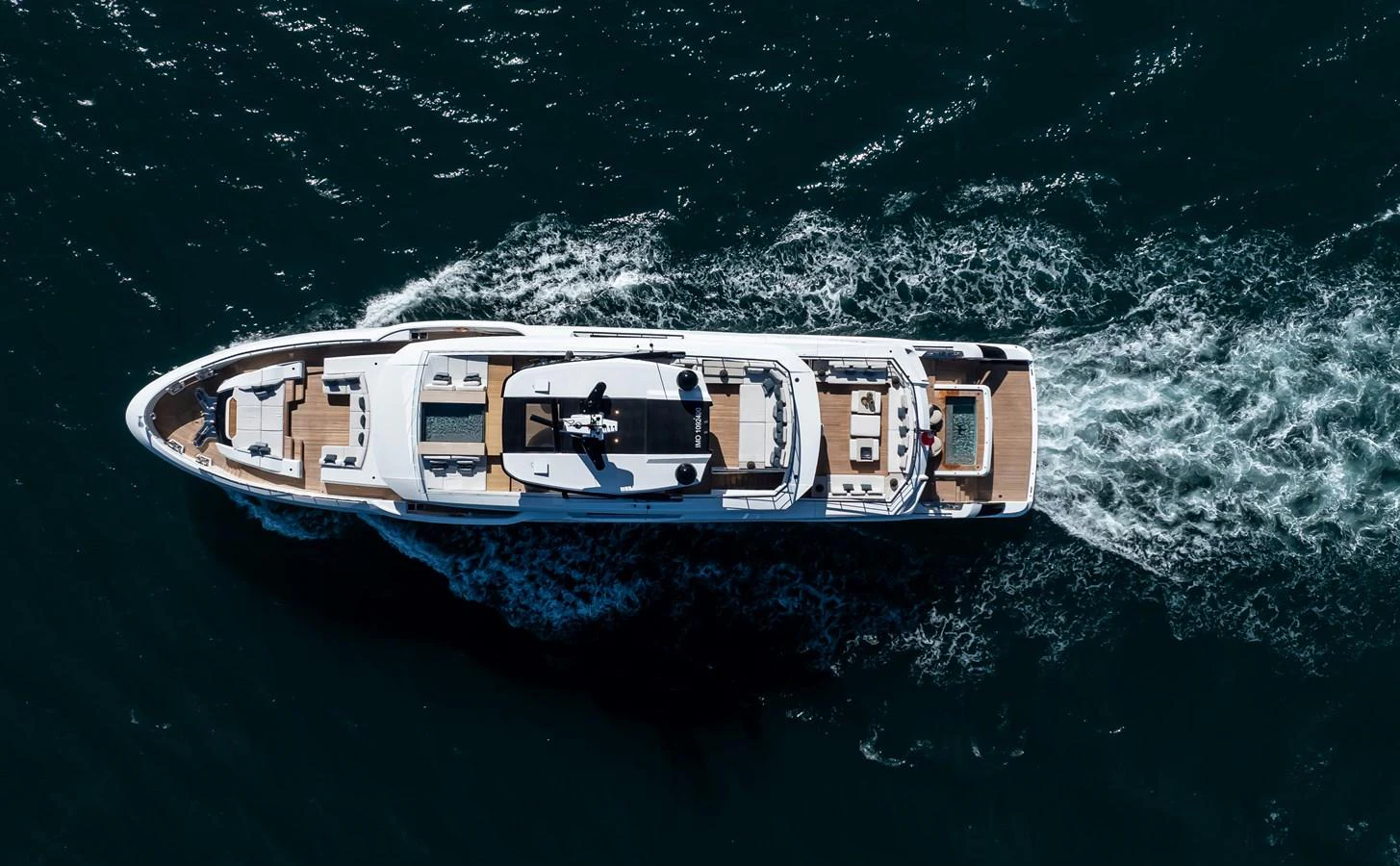 A sleek yacht cruises through the water, showcasing its elegant design from an aerial perspective. aboard ANDALA Yacht for Sale