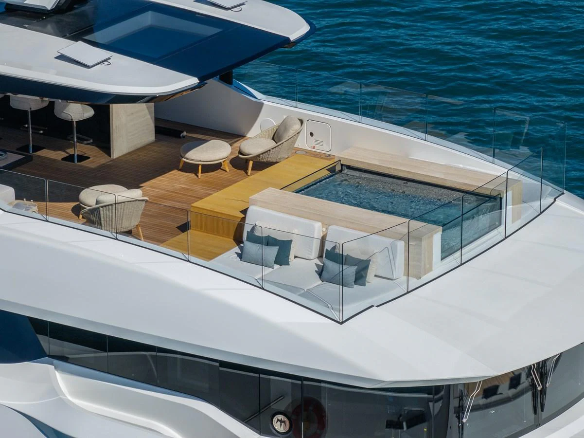 The yacht features a luxurious sundeck with a pool and stylish seating area. aboard ANDALA Yacht for Sale