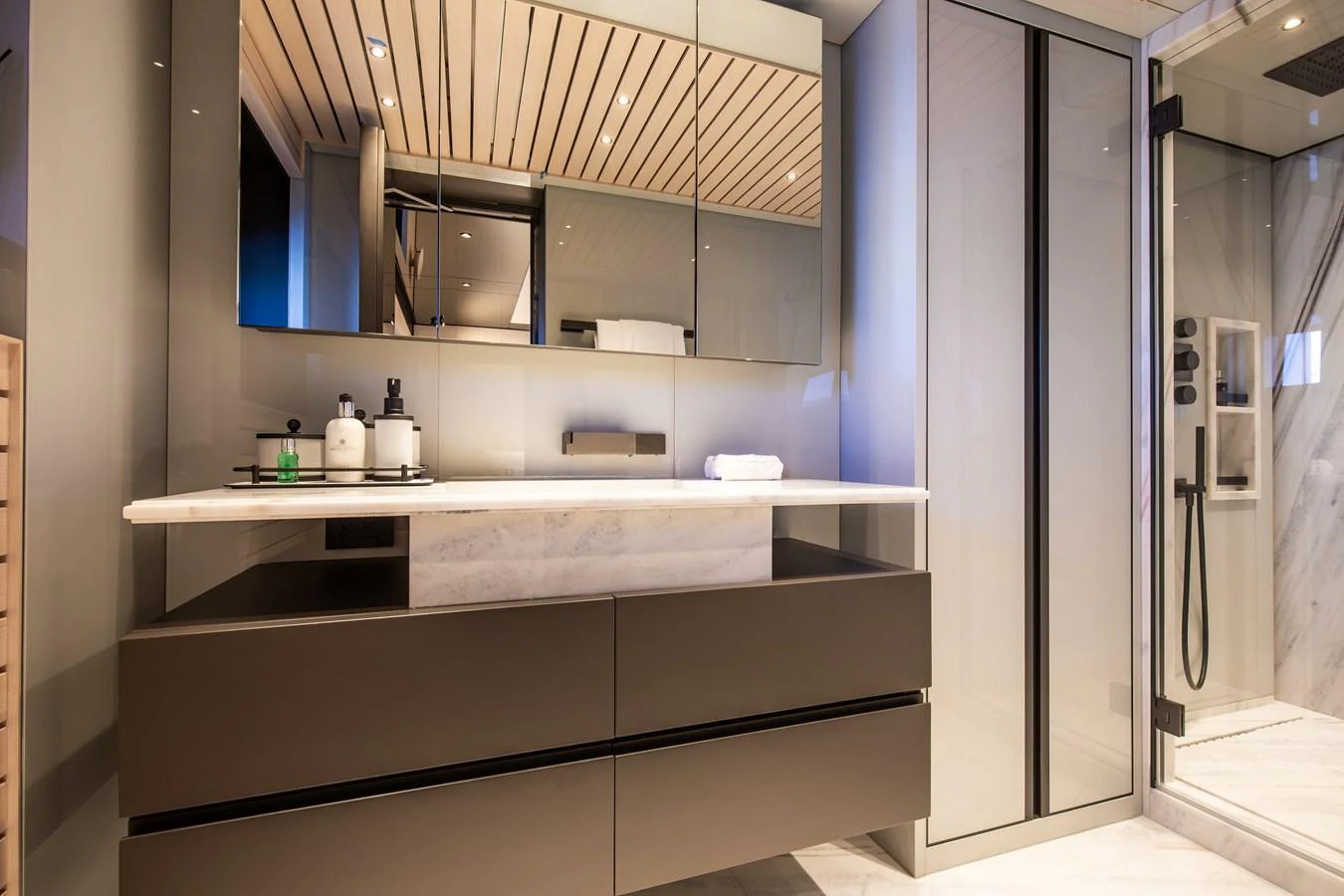The yacht's bathroom features a sleek modern design with a spacious shower and elegant vanity. aboard ANDALA Yacht for Sale