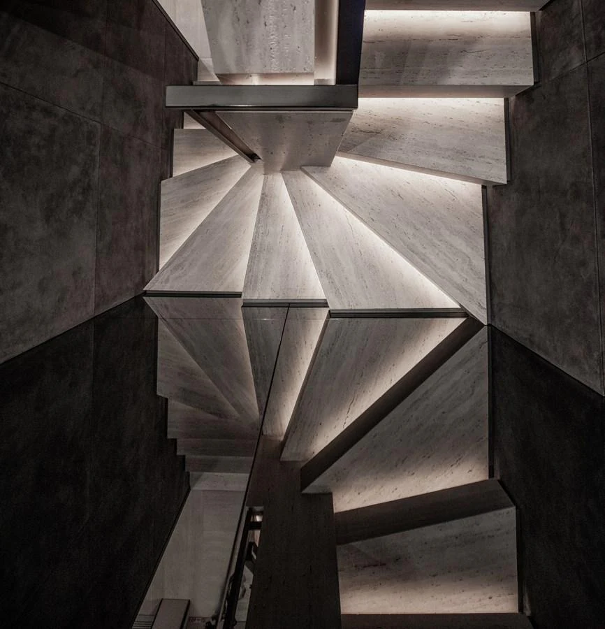 A modern, illuminated staircase with sleek, angular design elements. aboard ANDALA Yacht for Sale