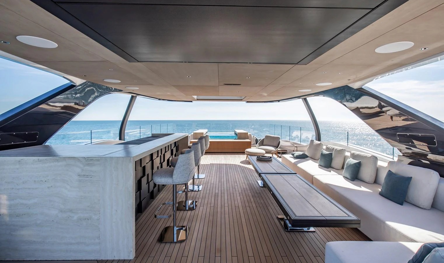 The spacious salon offers panoramic ocean views with luxurious seating and a sleek bar area. aboard ANDALA Yacht for Sale