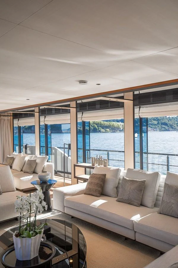 The salon offers a luxurious and comfortable space with panoramic views of the water. aboard ANDALA Yacht for Sale