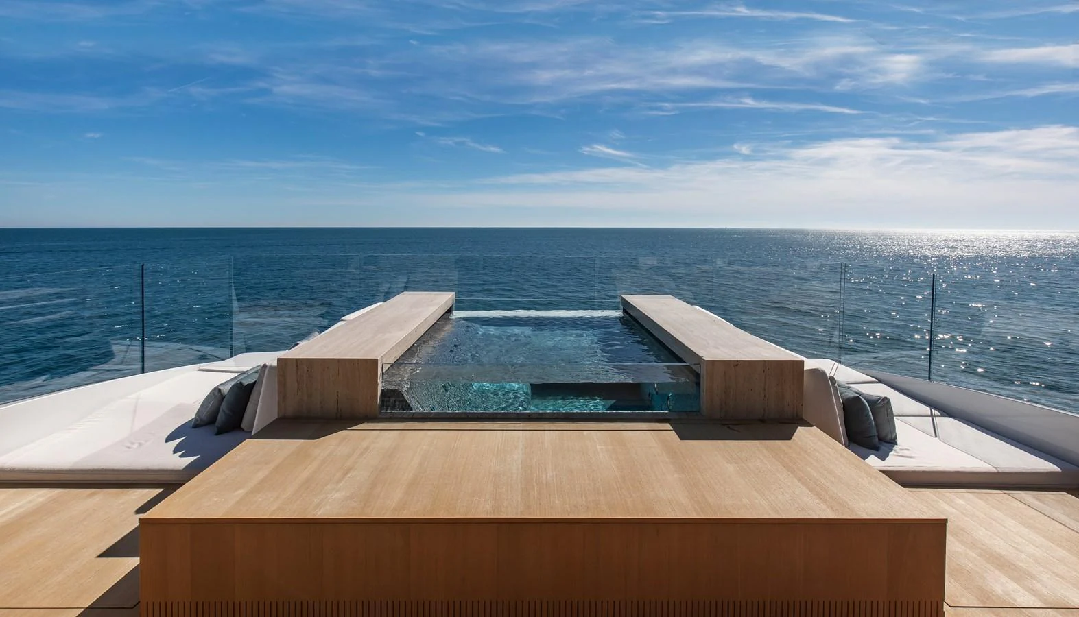 The yacht features a stunning pool deck with expansive ocean views. aboard ANDALA Yacht for Sale