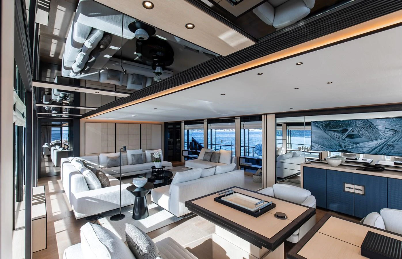 The salon offers a spacious and luxurious seating area with modern decor and large windows for stunning ocean views. aboard ANDALA Yacht for Sale