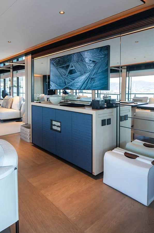 The salon features a modern entertainment center with a large flat-screen TV and stylish furnishings. aboard ANDALA Yacht for Sale