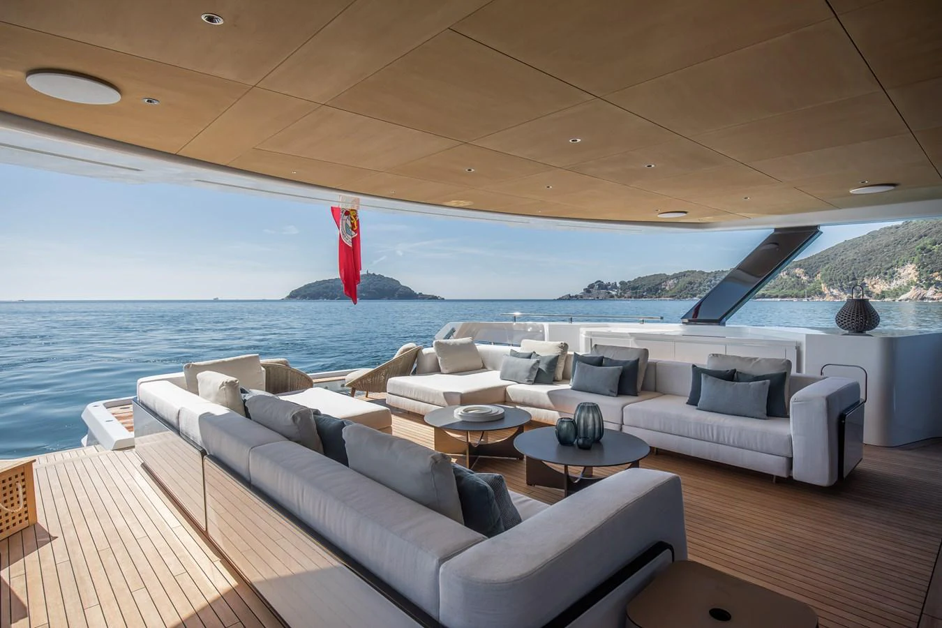 The aft deck offers a spacious and luxurious outdoor seating area with stunning ocean views. aboard ANDALA Yacht for Sale