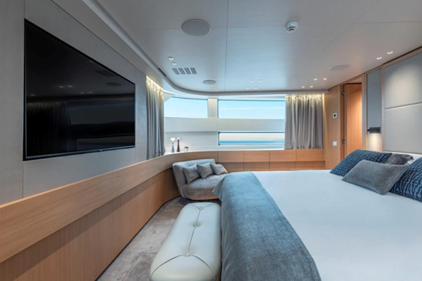 The master stateroom features a spacious bed, modern decor, and large windows offering stunning sea views. aboard FATSA Yacht for Sale