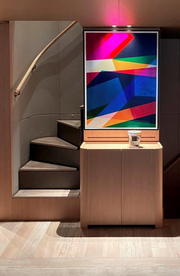 A stylish interior staircase with modern artwork and a sleek wooden finish. aboard FATSA Yacht for Sale