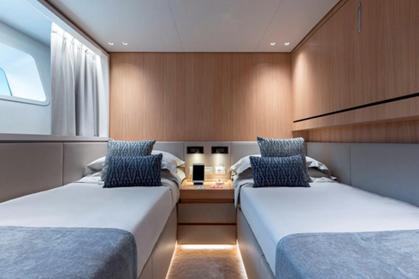The twin stateroom features two comfortable beds with elegant bedding and ample storage space. aboard FATSA Yacht for Sale