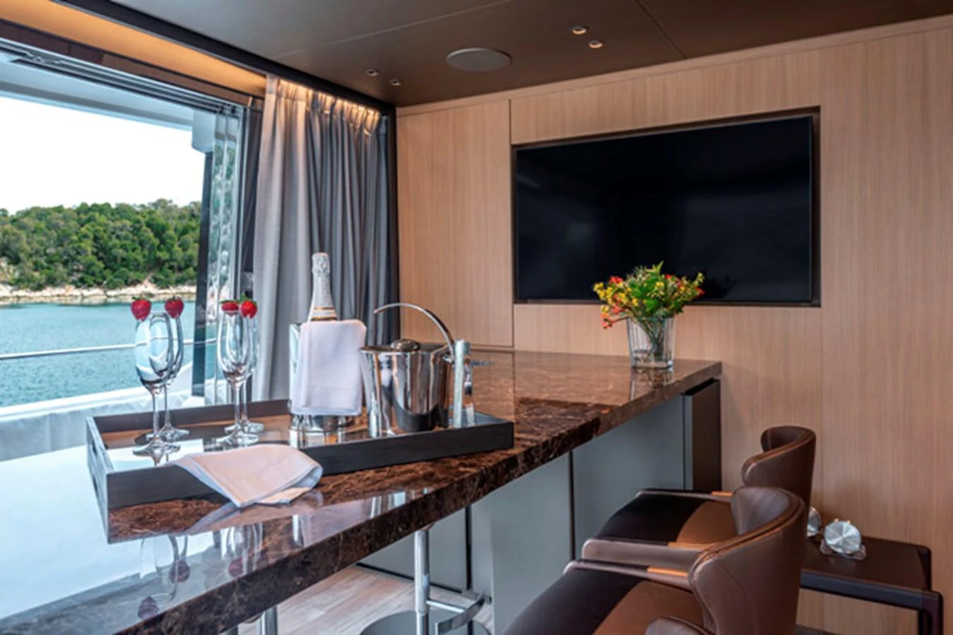 The yacht's interior features a stylish bar area with a marble countertop and comfortable seating. aboard FATSA Yacht for Sale