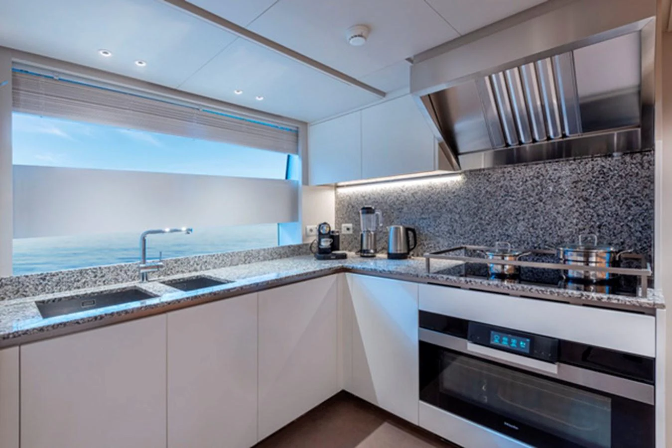 The yacht's galley is equipped with modern appliances and offers a stunning view through a large window. aboard FATSA Yacht for Sale