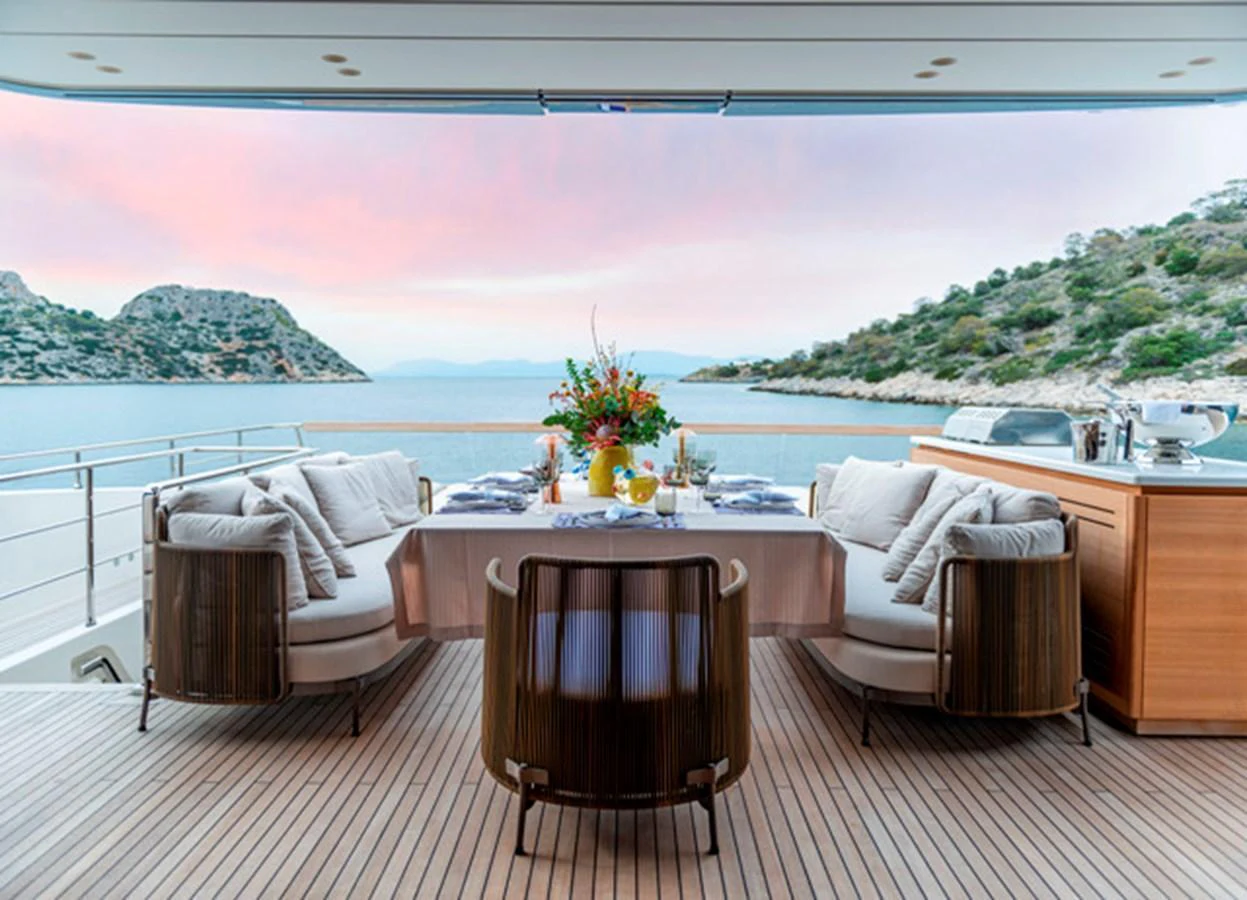 The aft deck offers a serene dining area with a stunning view of the surrounding waters and landscape. aboard FATSA Yacht for Sale