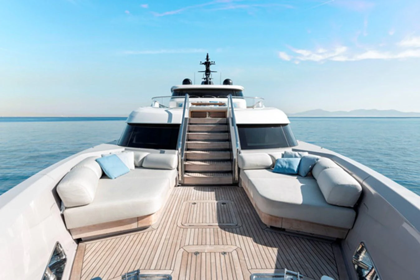 The yacht's foredeck features luxurious sun loungers and a serene ocean backdrop. aboard FATSA Yacht for Sale