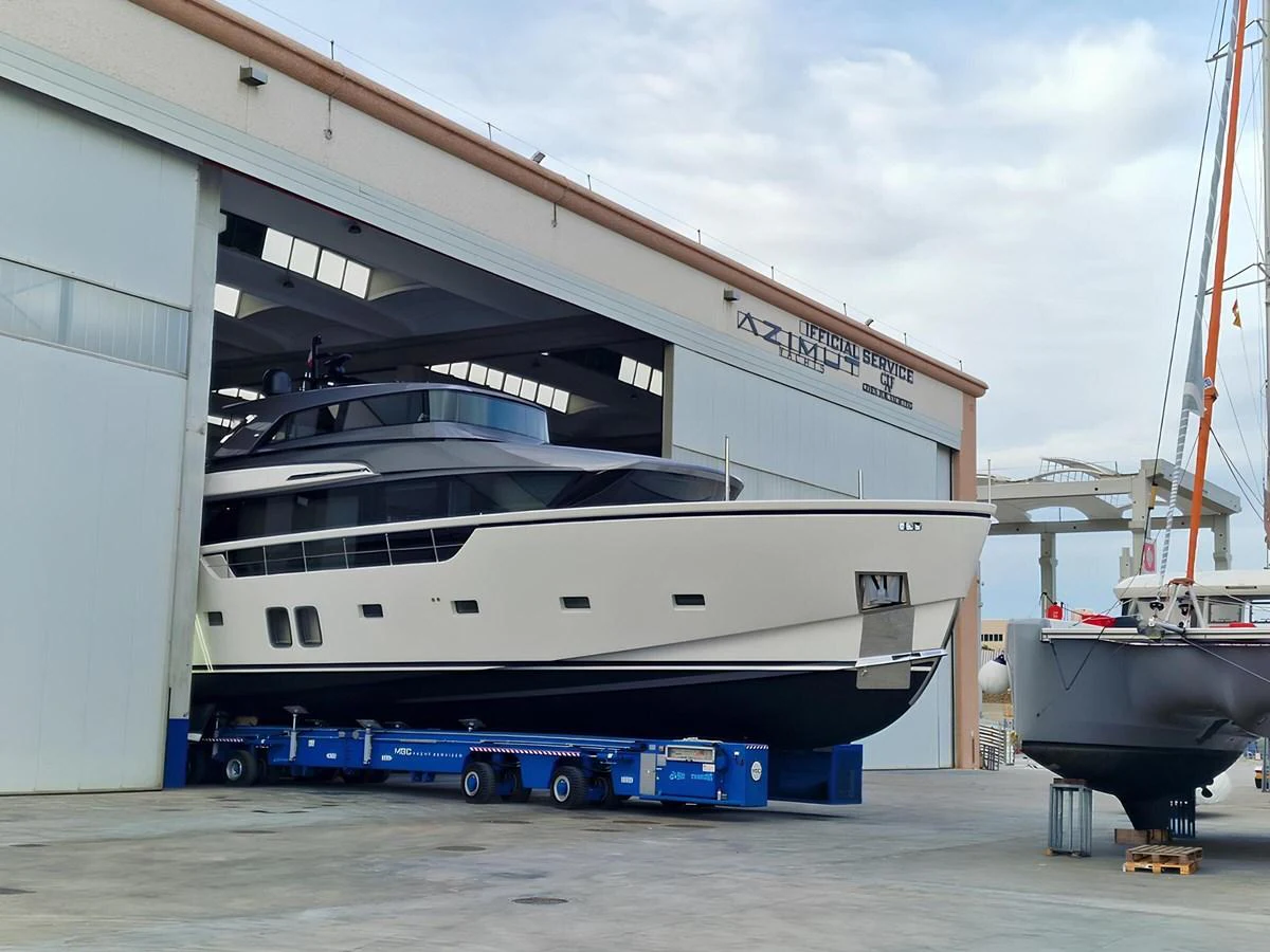 The yacht is seen in a shipyard, partially inside a large building, ready for maintenance or launch. aboard LYDIA Yacht for Sale