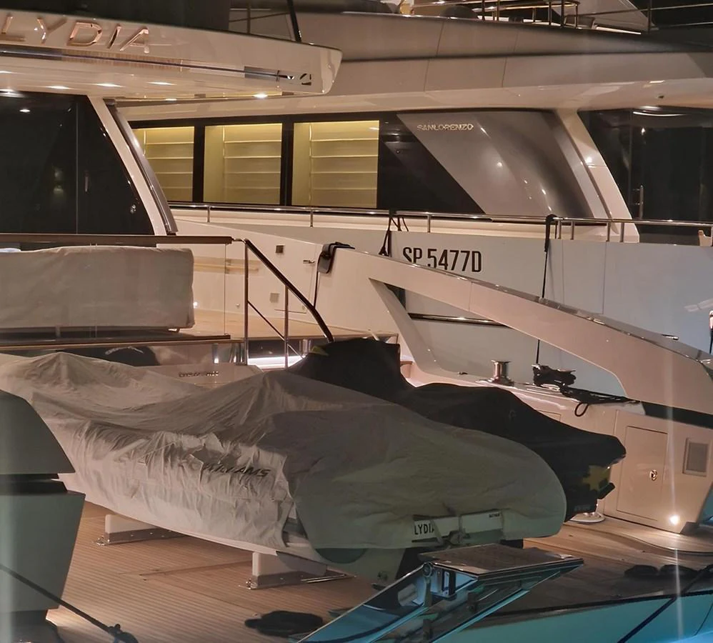 The image showcases a covered tender on the deck of a yacht, with the yacht's exterior visible in the background. aboard LYDIA Yacht for Sale