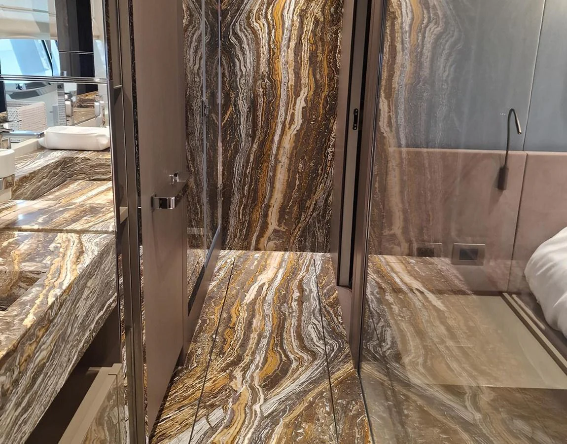 The yacht's interior features luxurious marble surfaces and modern design elements. aboard LYDIA Yacht for Sale