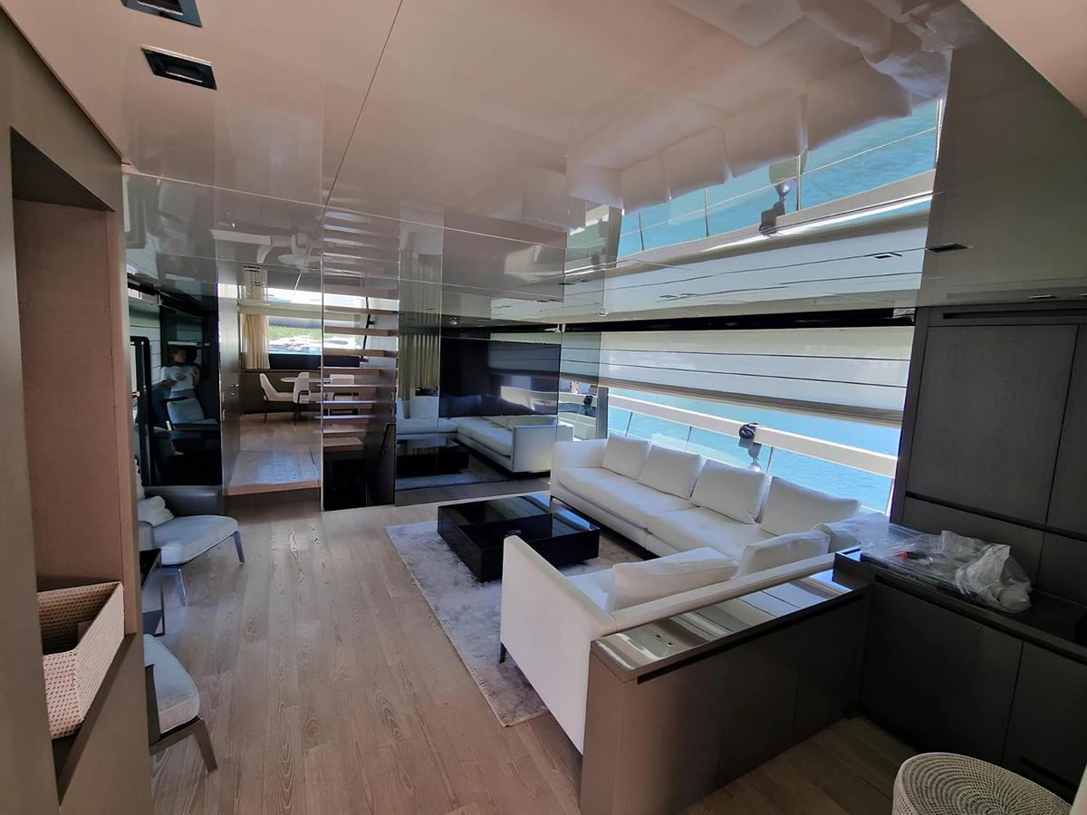 The yacht's salon features modern furnishings with ample natural light and a comfortable seating area. aboard LYDIA Yacht for Sale