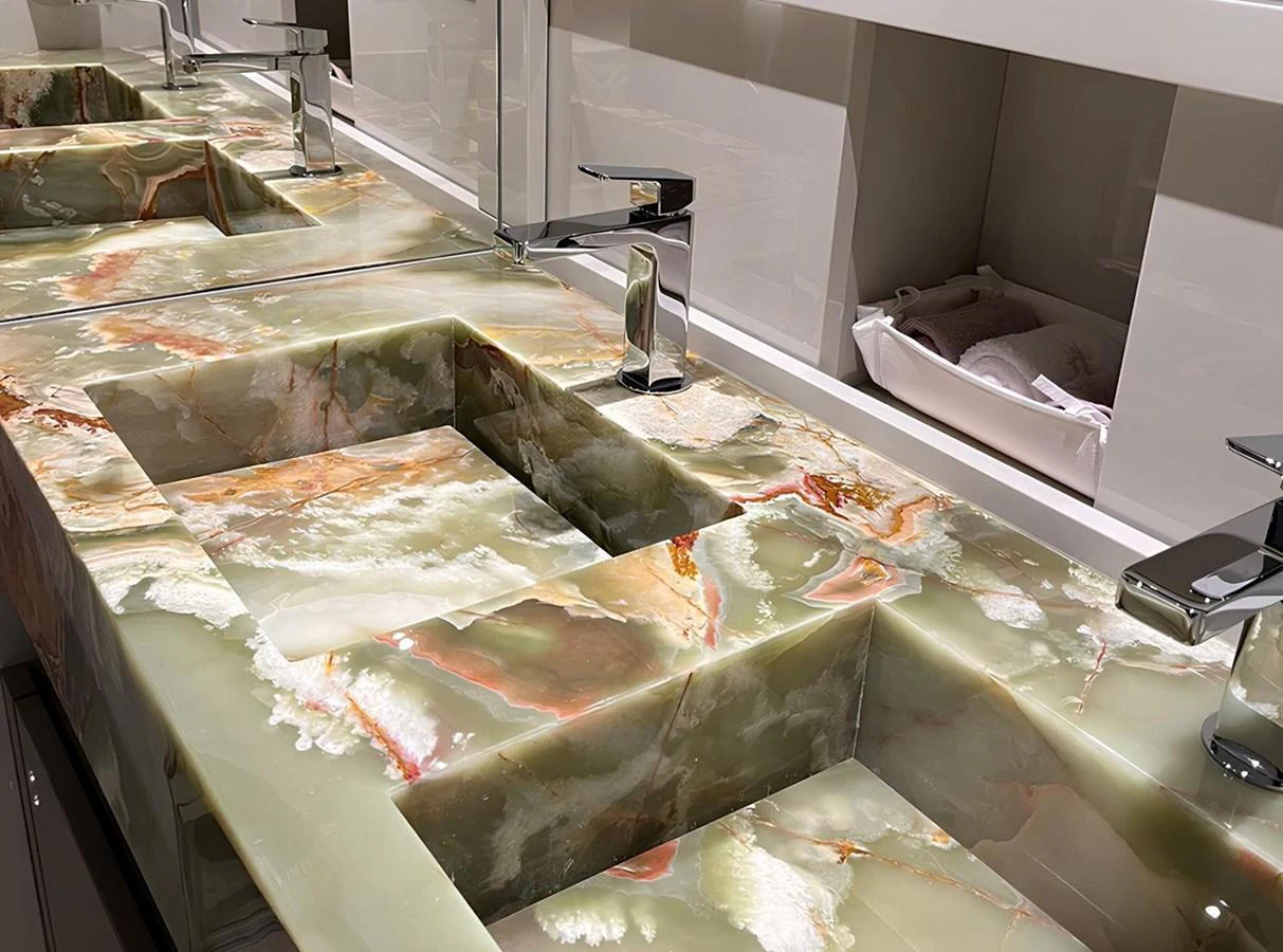 The image showcases a luxurious bathroom sink area with elegant marble countertops. aboard LYDIA Yacht for Sale