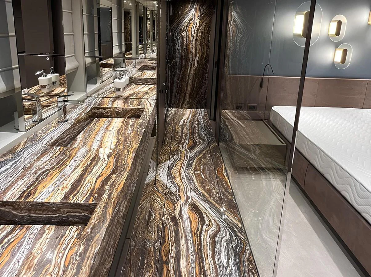 The luxurious bathroom features a stunning marble countertop and modern fixtures. aboard LYDIA Yacht for Sale