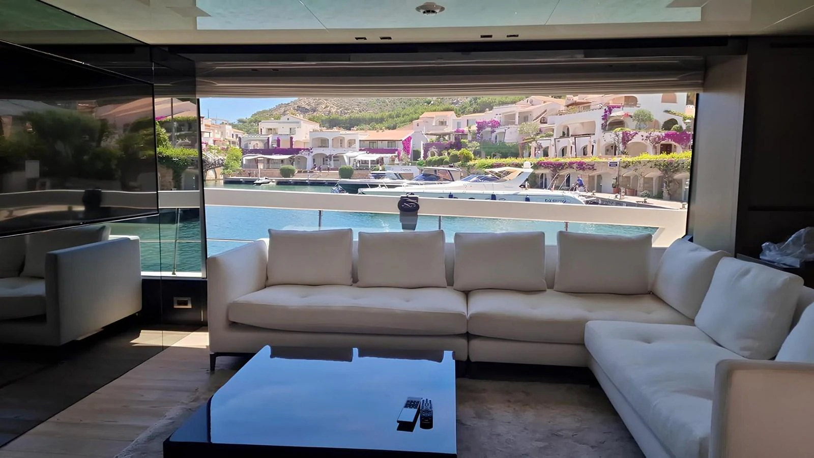The salon offers a spacious and comfortable seating area with a stunning view of the marina. aboard LYDIA Yacht for Sale