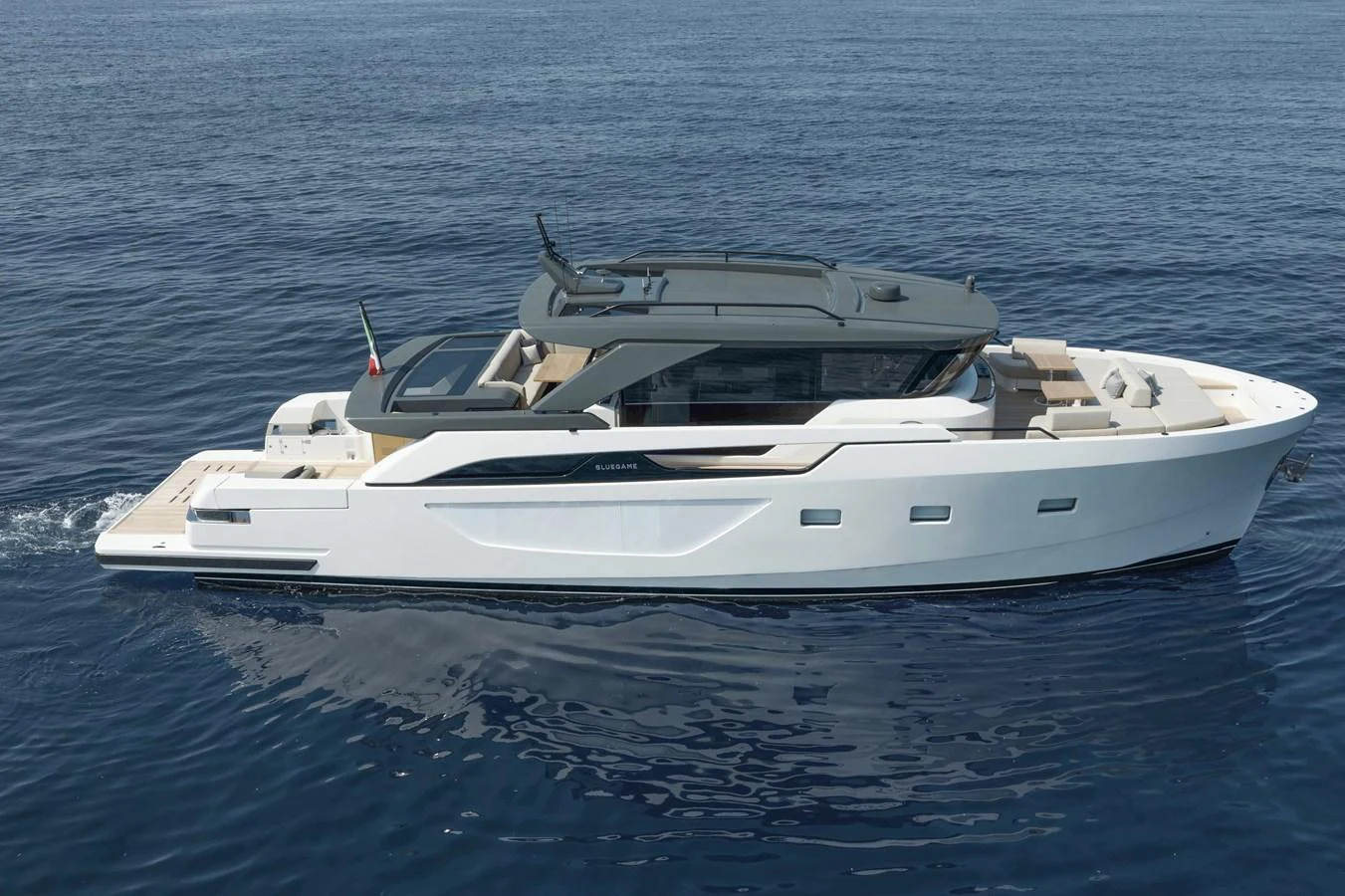A sleek and modern yacht cruising on calm waters, showcasing its elegant design and spacious deck areas. aboard BLUEGAME BGX63 #49 Yacht for Sale