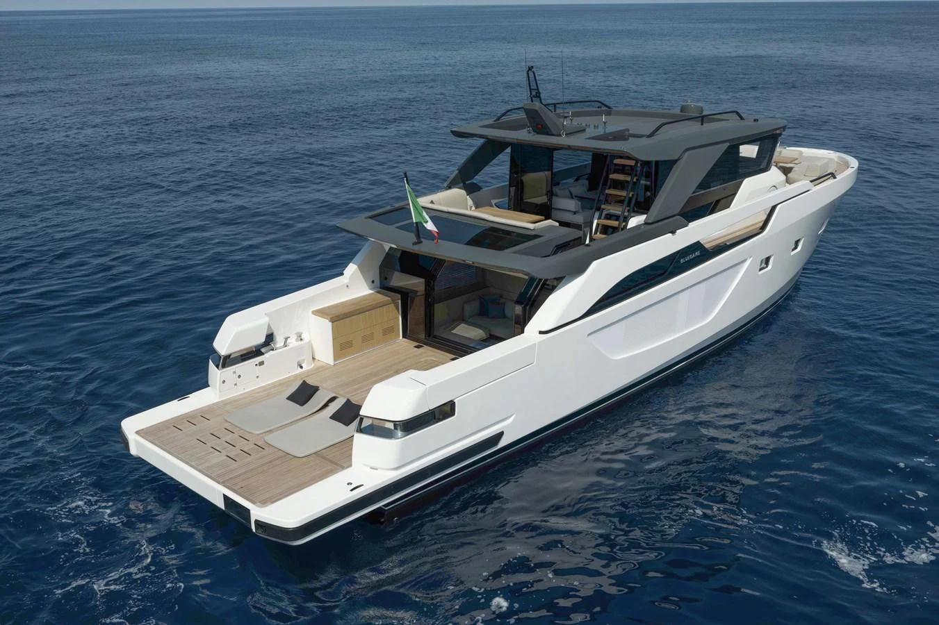A sleek and modern yacht cruising on calm blue waters, showcasing its stylish design and spacious deck. aboard BLUEGAME BGX63 #49 Yacht for Sale