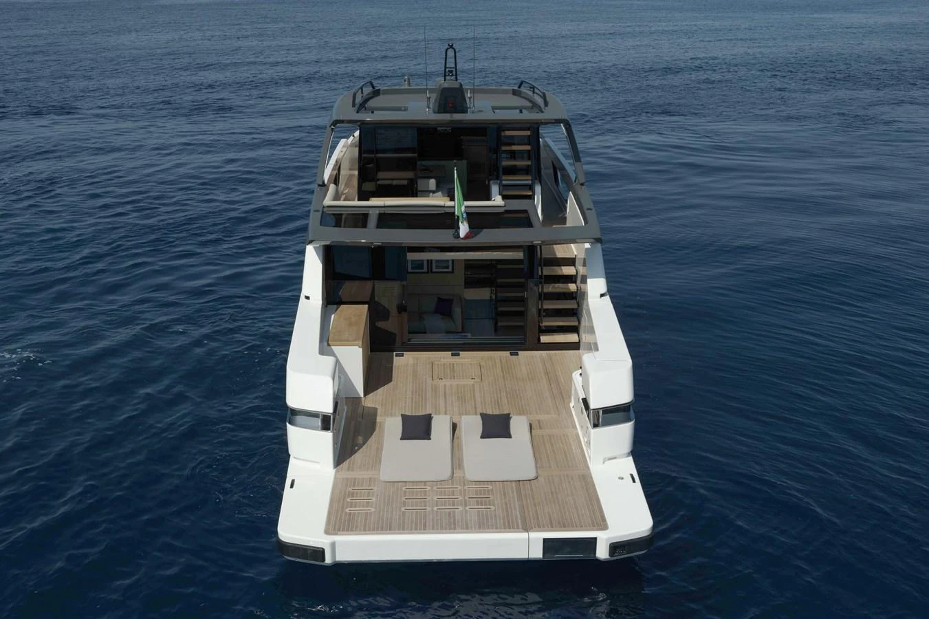 The yacht features a spacious aft deck with sun loungers and a modern design. aboard BLUEGAME BGX63 #49 Yacht for Sale