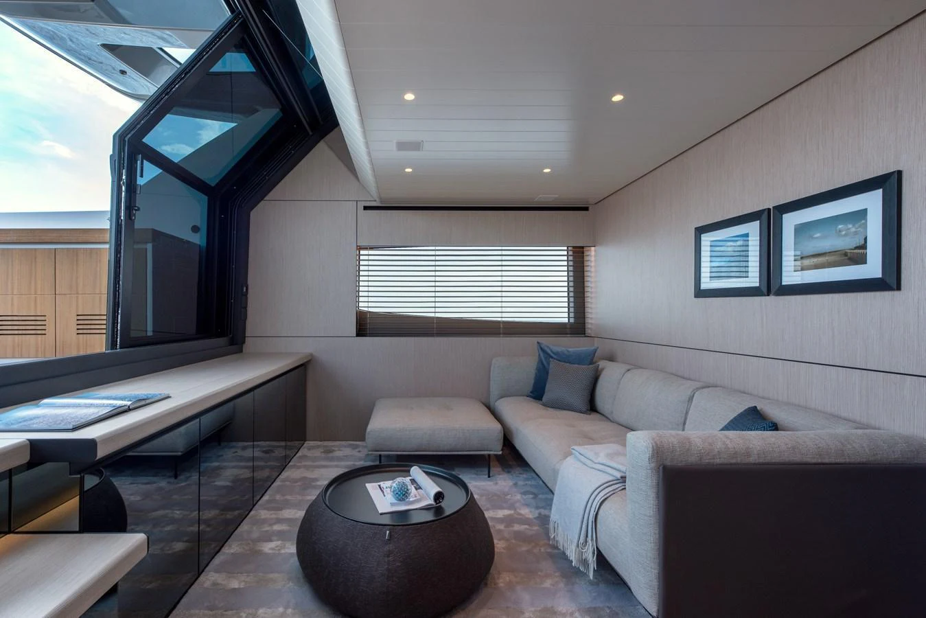 The salon features a comfortable seating area with modern decor and large windows for natural light. aboard BLUEGAME BGX63 #49 Yacht for Sale
