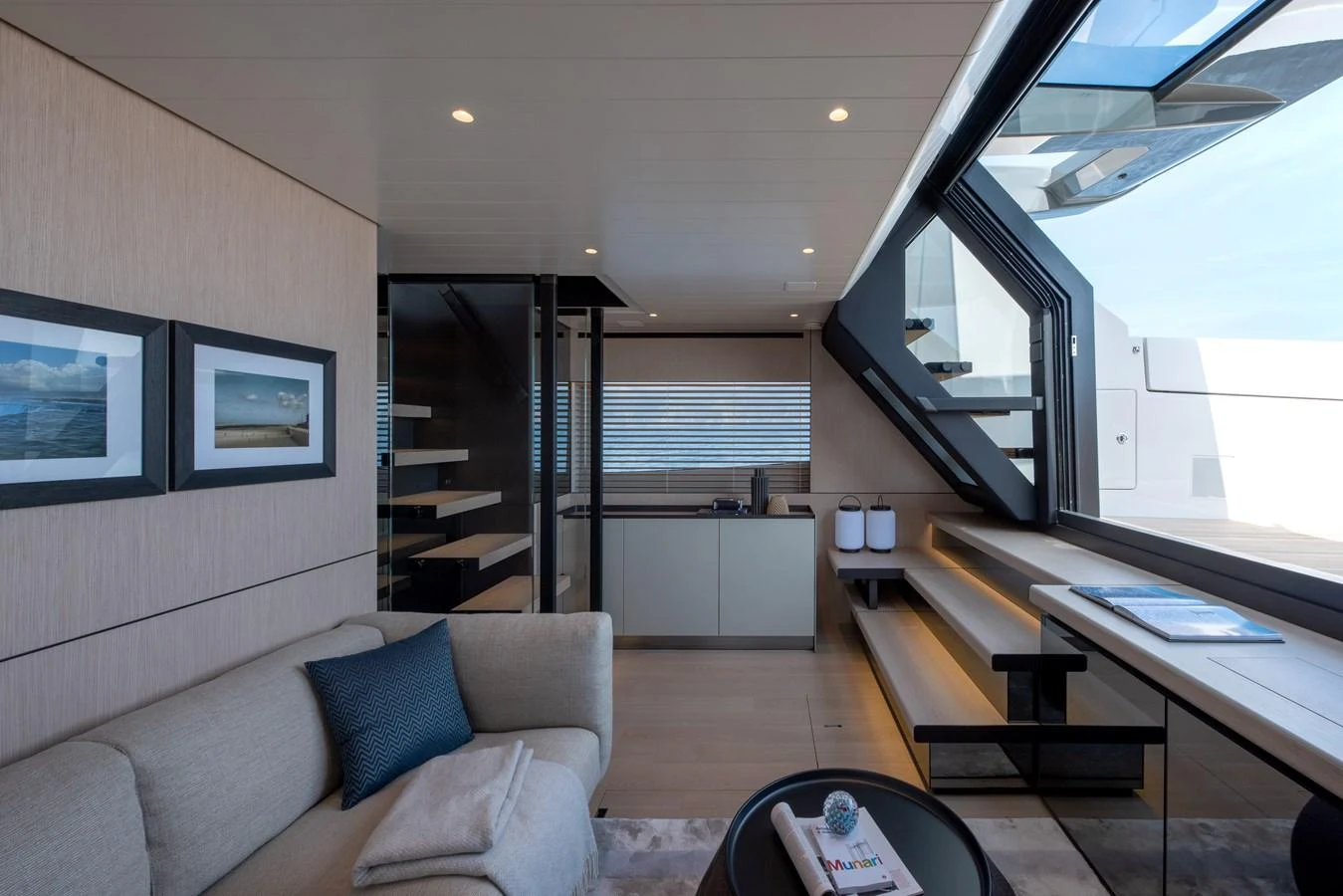 The salon features modern furnishings with large windows offering ample natural light. aboard BLUEGAME BGX63 #49 Yacht for Sale