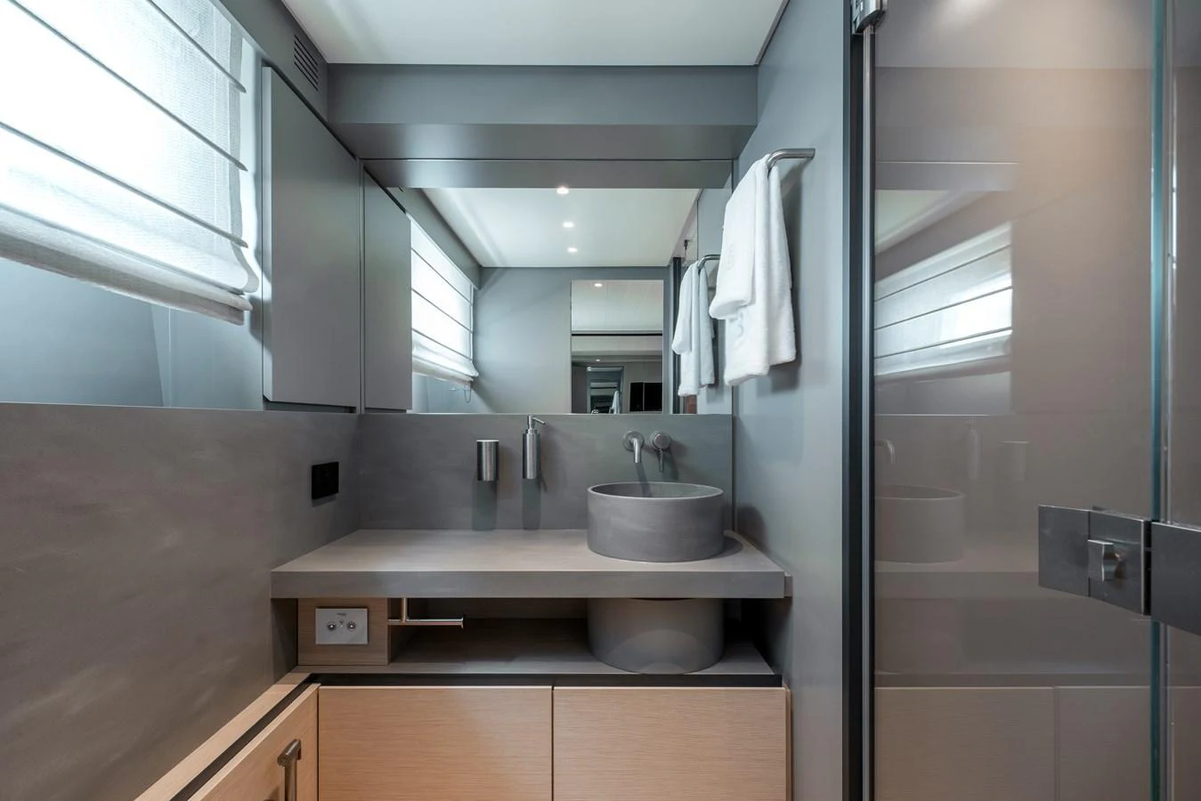 The yacht's bathroom features a modern design with sleek fixtures and ample lighting. aboard BLUEGAME BGX63 #49 Yacht for Sale