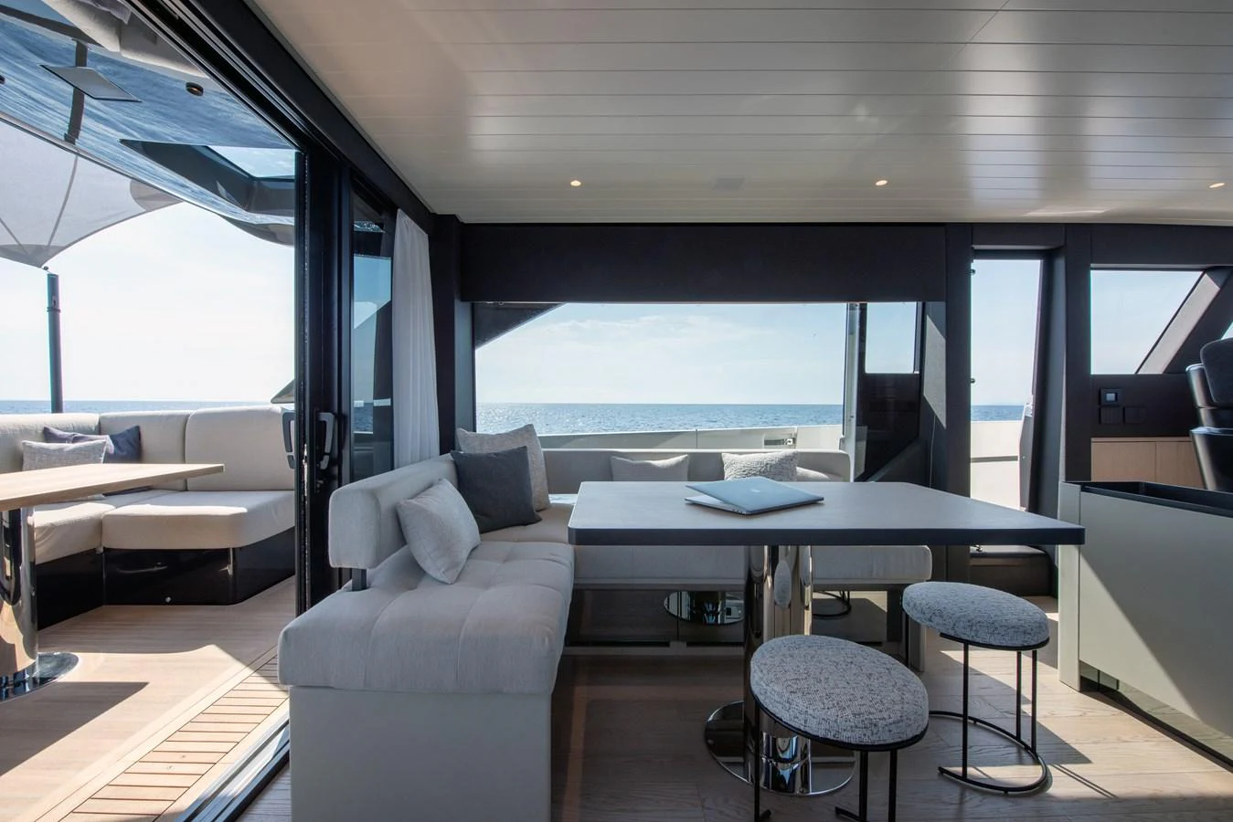The yacht's salon offers a spacious and modern seating area with panoramic ocean views. aboard BLUEGAME BGX63 #49 Yacht for Sale