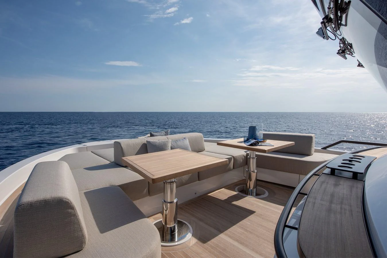 The yacht's aft deck offers a luxurious seating area with stunning ocean views. aboard BLUEGAME BGX63 #49 Yacht for Sale