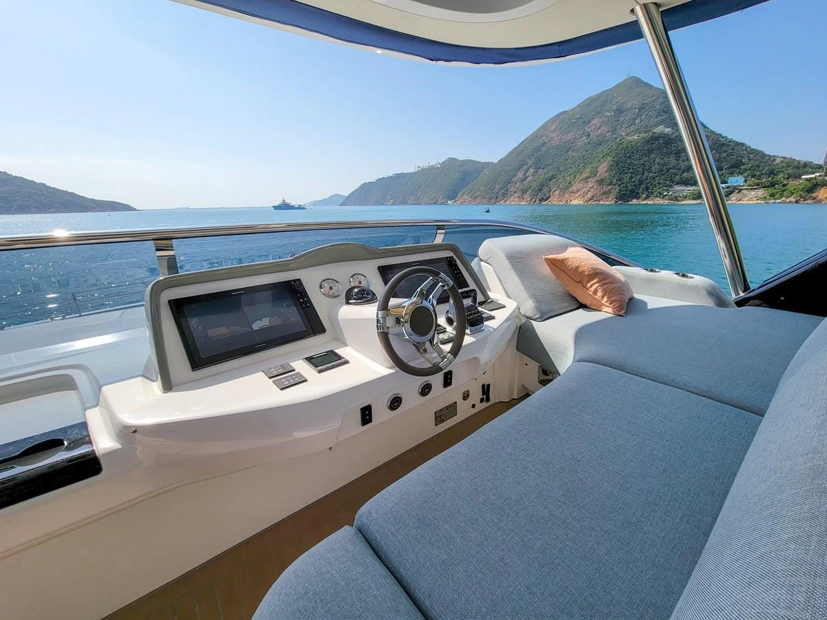 The helm offers a comfortable and scenic view of the surrounding waters and mountains. aboard LAGOON SIXTY 7 Yacht for Sale