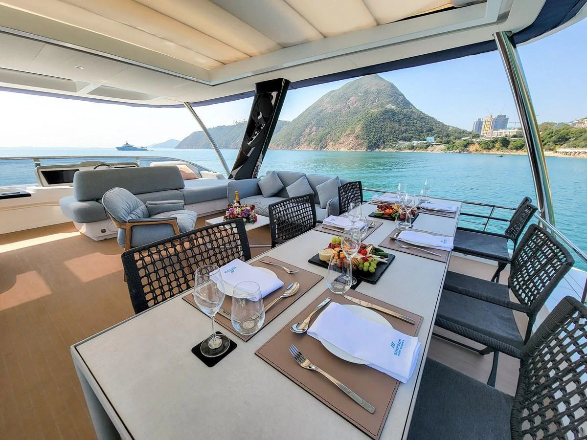 The aft deck features an elegant dining area with stunning ocean views. aboard LAGOON SIXTY 7 Yacht for Sale