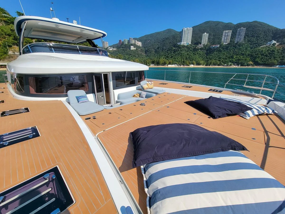 The yacht's spacious foredeck features comfortable sun pads and stunning views of the coastline. aboard LAGOON SIXTY 7 Yacht for Sale