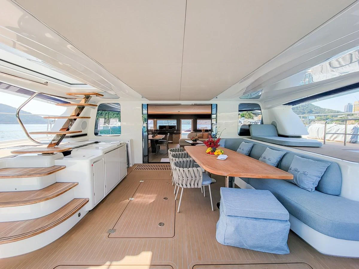 The spacious salon features elegant seating and a dining area with panoramic views. aboard LAGOON SIXTY 7 Yacht for Sale