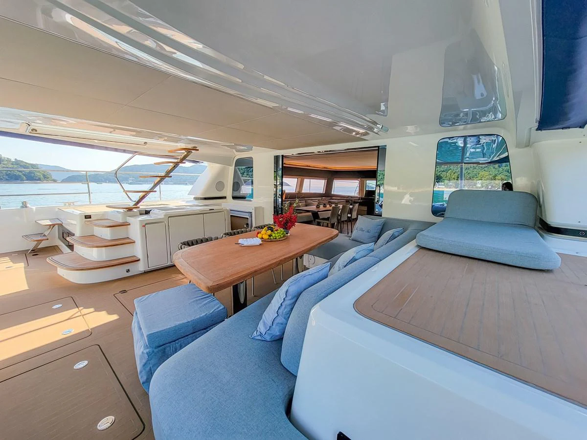 The spacious salon features comfortable seating and a dining area with a view of the water. aboard LAGOON SIXTY 7 Yacht for Sale