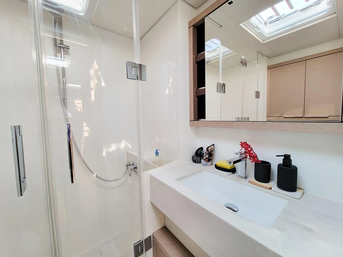 A modern yacht bathroom with a sleek design and ample natural light. aboard LAGOON SIXTY 7 Yacht for Sale